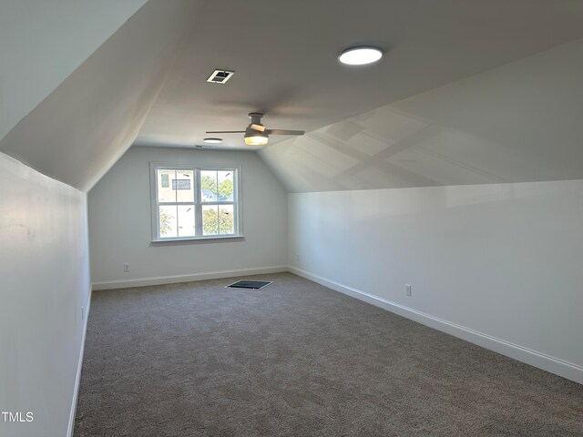 bonus room with vaulted ceiling, carpet, and ceiling fan