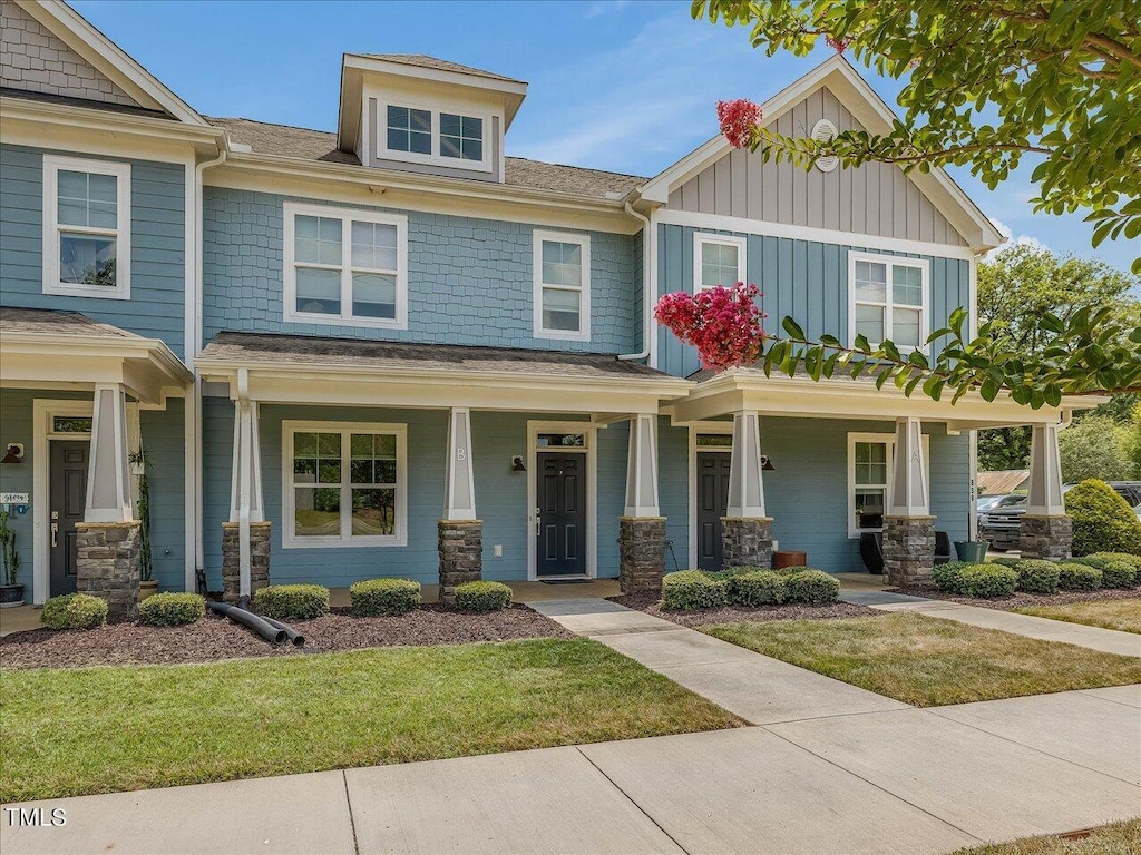 craftsman-style home with covered porch and a front yard