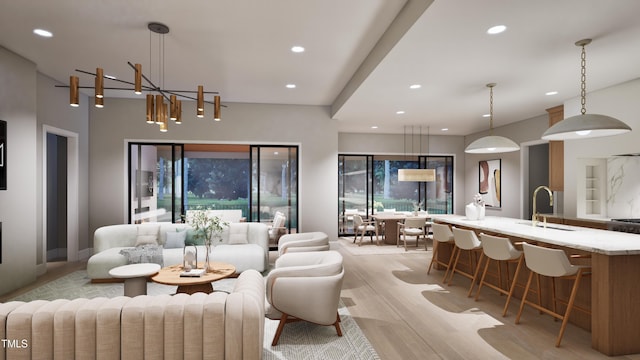 living room with sink and light hardwood / wood-style floors