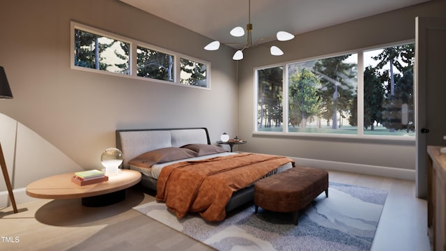 bedroom with a notable chandelier and hardwood / wood-style flooring