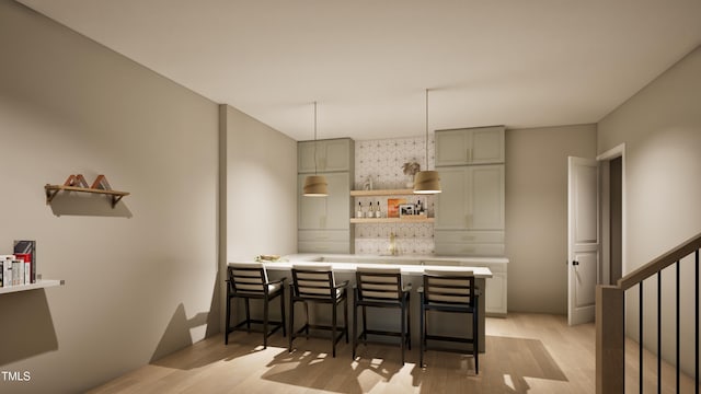 kitchen featuring a kitchen breakfast bar, kitchen peninsula, and light wood-type flooring