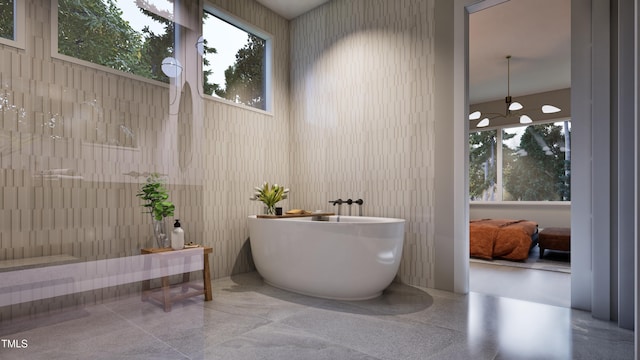 bathroom featuring a towering ceiling and a bathing tub