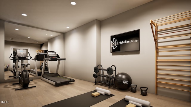 exercise room with light hardwood / wood-style flooring