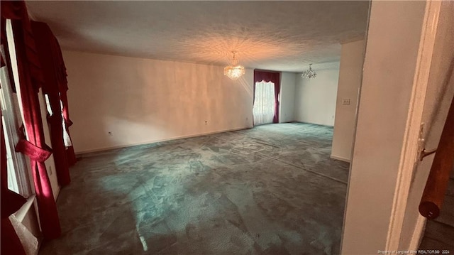 unfurnished room with plenty of natural light and a chandelier