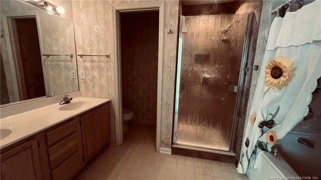 full bathroom featuring toilet, separate shower and tub, vanity, and tile patterned floors