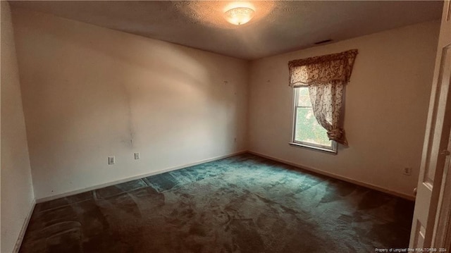 empty room featuring dark carpet