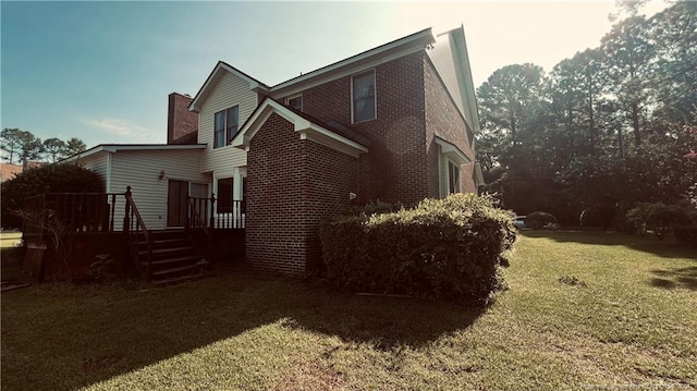 exterior space featuring a deck and a lawn