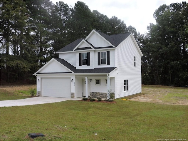 view of front of property with a front yard and a garage