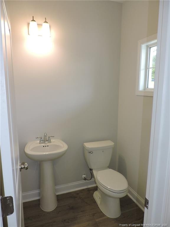 bathroom with wood-type flooring and toilet