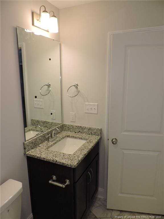 bathroom with vanity and toilet