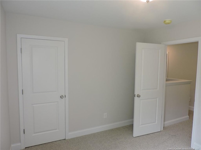 unfurnished bedroom featuring light colored carpet