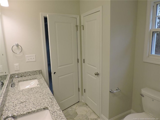 bathroom featuring tile patterned floors, vanity, and toilet