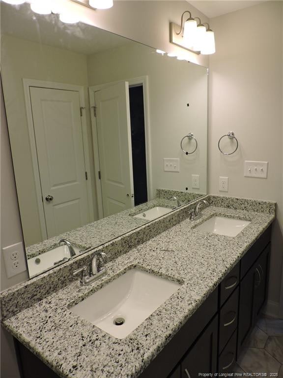 bathroom with tile patterned flooring and vanity