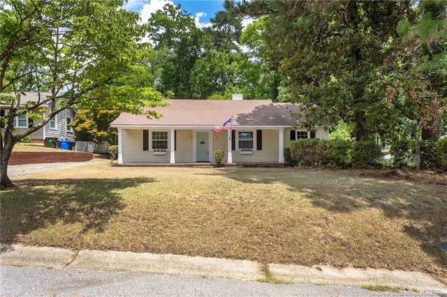 ranch-style house with a front yard and covered porch