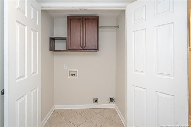 laundry room with hookup for a washing machine, cabinet space, baseboards, and light tile patterned floors