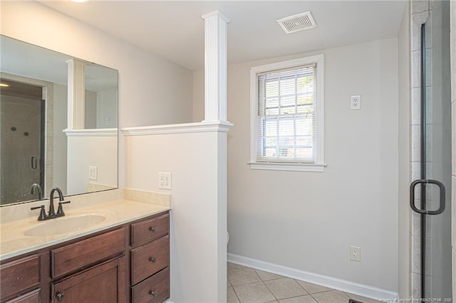 bathroom with tile patterned flooring, vanity, visible vents, a shower stall, and decorative columns