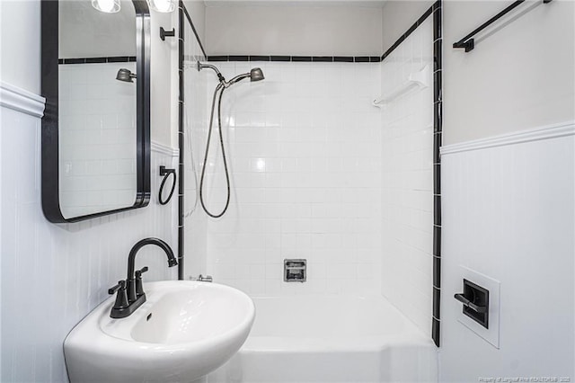 full bathroom featuring washtub / shower combination and a sink