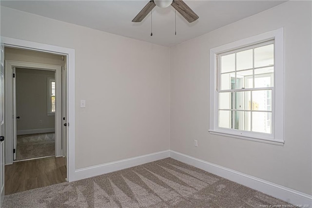 unfurnished room featuring carpet, baseboards, and ceiling fan