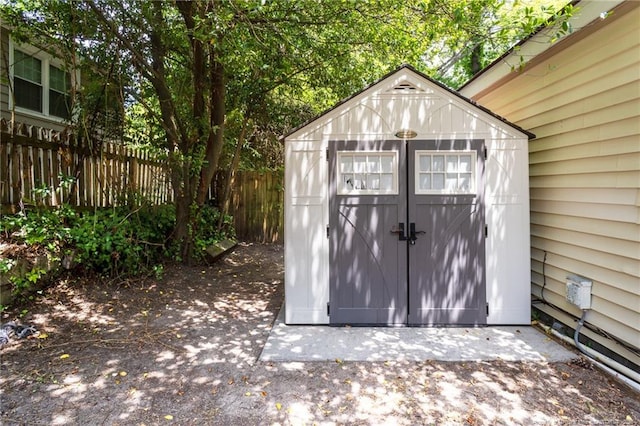 view of shed featuring fence