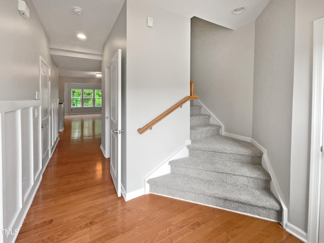 stairs featuring light wood-type flooring