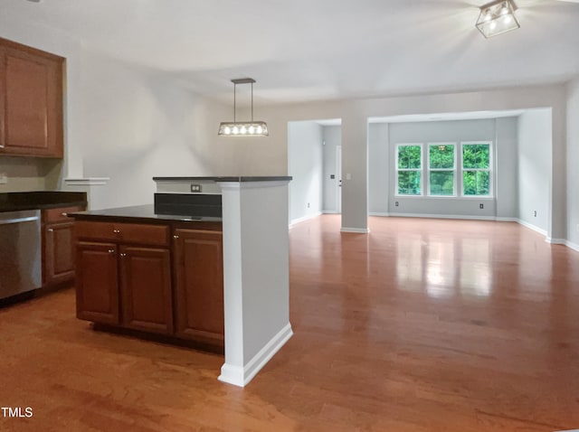 kitchen featuring a notable chandelier, decorative light fixtures, dishwasher, and hardwood / wood-style floors