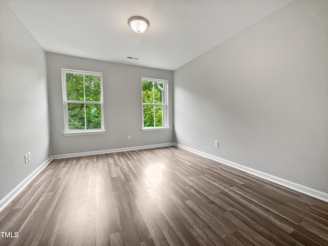 spare room with dark hardwood / wood-style flooring