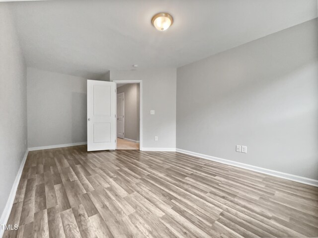 unfurnished bedroom featuring hardwood / wood-style flooring