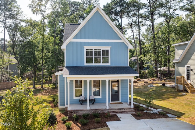 view of front of house with a porch and a front yard