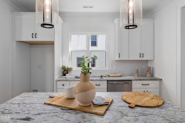 kitchen featuring white cabinetry, light stone counters, and stainless steel dishwasher