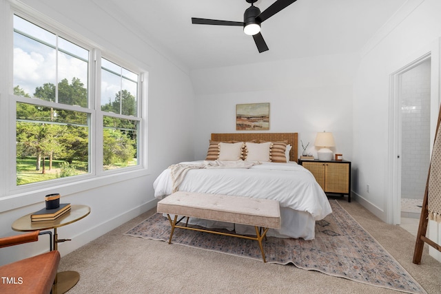 bedroom featuring connected bathroom, light colored carpet, and ceiling fan