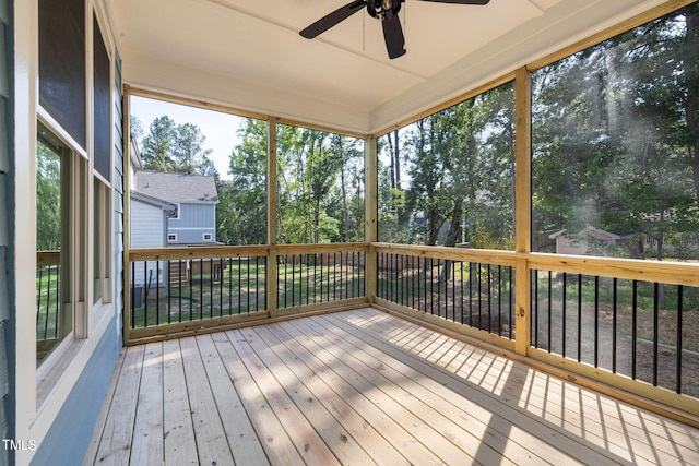 unfurnished sunroom with ceiling fan