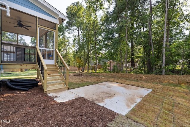 view of yard with a patio area, a sunroom, and ceiling fan