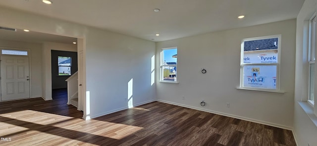 unfurnished room featuring dark wood-type flooring