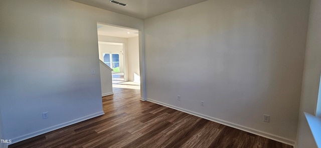 unfurnished room featuring dark wood-type flooring