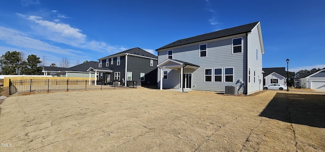 rear view of house featuring central AC unit