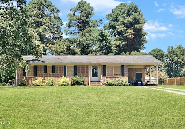 ranch-style home with a carport and a front lawn