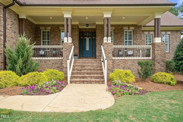 entrance to property featuring a porch