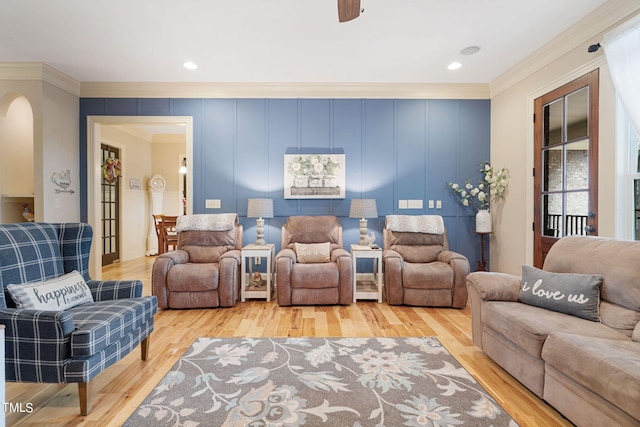 living room featuring crown molding and light hardwood / wood-style flooring