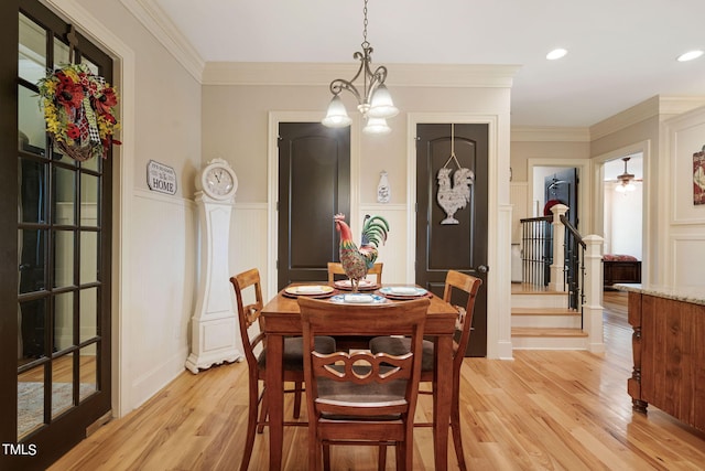 dining space featuring crown molding and light hardwood / wood-style floors