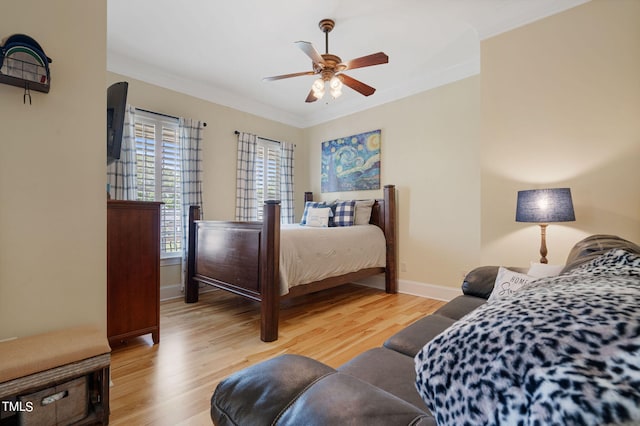 bedroom featuring ornamental molding, ceiling fan, and light wood-type flooring