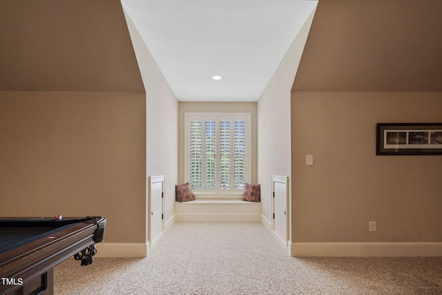 hallway featuring light carpet and lofted ceiling