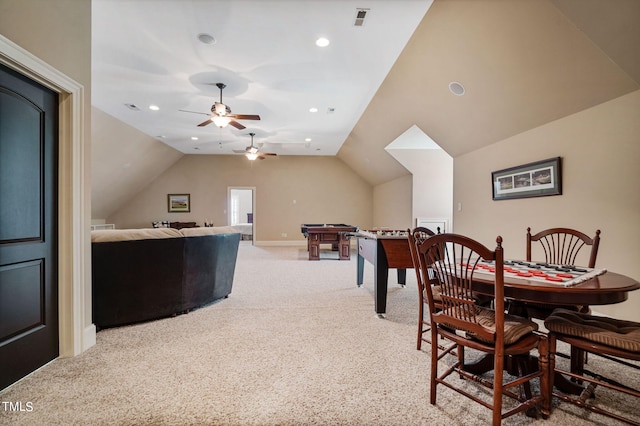 dining room featuring light carpet and lofted ceiling