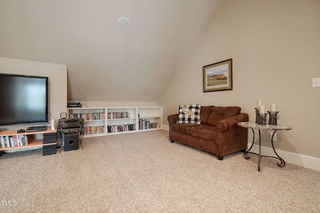 carpeted living room featuring lofted ceiling and built in shelves