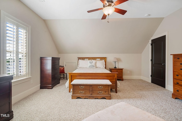 carpeted bedroom featuring ceiling fan, lofted ceiling, and multiple windows