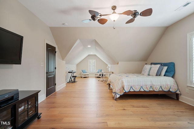 bedroom featuring ceiling fan, lofted ceiling, and light hardwood / wood-style flooring