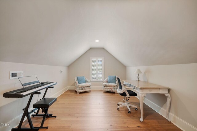 office featuring lofted ceiling and light wood-type flooring