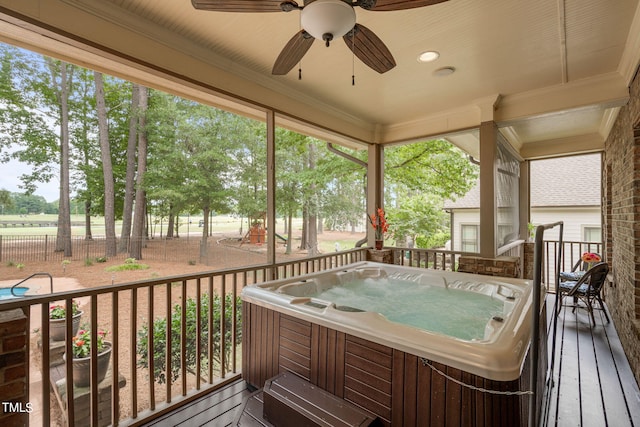 deck featuring a hot tub and ceiling fan