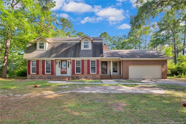 cape cod home with a garage and a front lawn