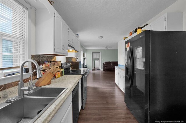 kitchen with tasteful backsplash, black appliances, white cabinets, sink, and dark hardwood / wood-style floors