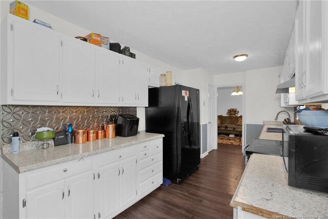 kitchen with tasteful backsplash, dark hardwood / wood-style floors, ventilation hood, white cabinetry, and black refrigerator with ice dispenser